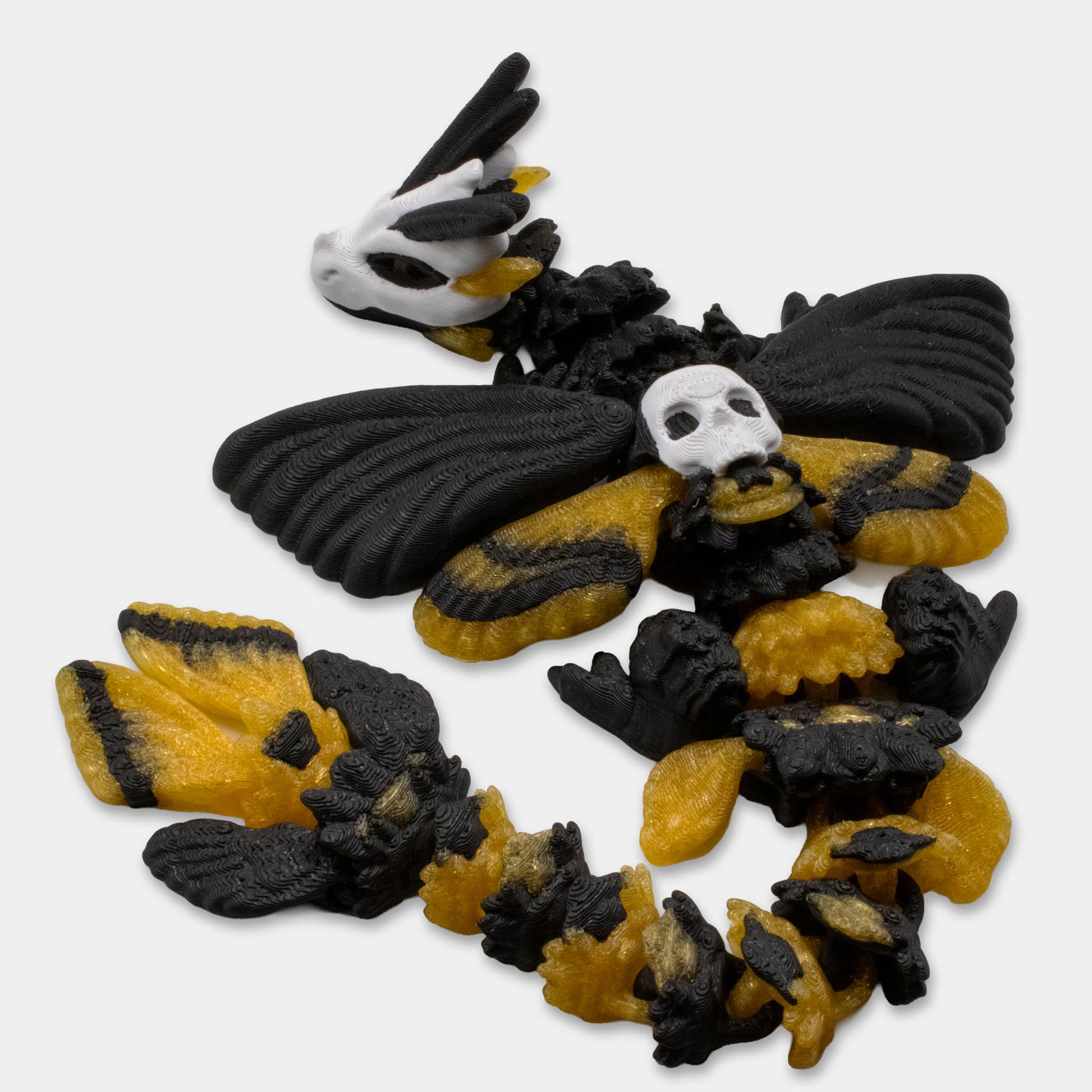 3D printed Death’s Head Moth Dragon by Cinderwing3D in black and yellow with wings spread.