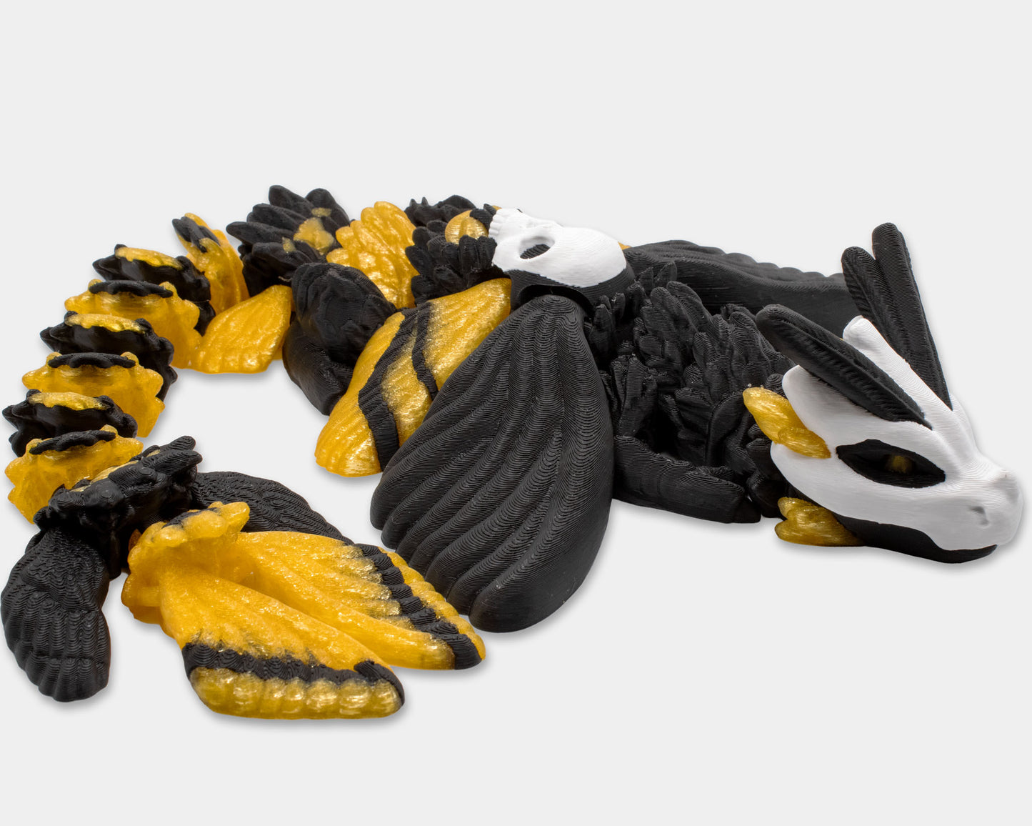 Articulated Death’s Head Moth Dragon posed on its side with tail curled